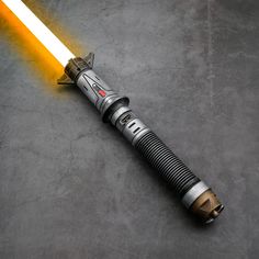 a star wars light saber laying on the ground