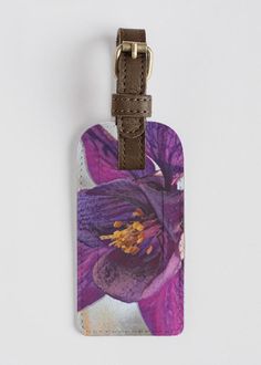 Purple Colorado Columbine. Stand out everywhere from boarding to baggage claim with a custom-printed VIDA luggage accent tag. Crafted from smooth leather, this tag features an antiqued metal buckle and a covered ID window. Audacity Press original. Baggage Claim, Antique Metal, Metal Buckles, Smooth Leather, Buckle