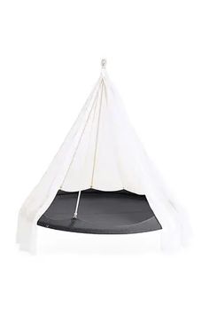 a white teepee tent with a black floor and gray ground mat on top of it