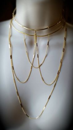 This choker is so lovely! Perfect for layering with other pieces. We took hallowed out curved bar/tube beads and added faceted cut gold beads in between each gold tube. They are very light weight and comfortable to wear. The center of the choker has a short uneven tassel made with 14k gold fill chains.The back of the choker has a lobster clasp and 3" inch extension chain.*This choker is available in 14k gold fill or sterling silver. Gold Lariat Necklace With Adjustable Chain For Festival, Adjustable Brass Choker For Parties, Adjustable Gold Lariat Choker, Handmade Gold Choker Bib Necklace, Adjustable Gold Multi-strand Choker, Gold Fringe Metal Necklaces, Gold Multi-strand Metal Choker, 14k Gold-filled Yellow Gold Chain Choker Necklace, Gold Fringe Metal Necklace