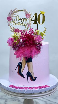 a birthday cake decorated with pink flowers and high heeled shoes for a woman's 40 year old