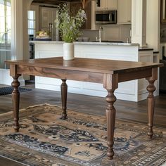 a wooden table sitting on top of a rug in a kitchen