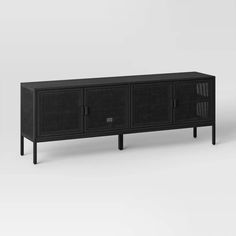 a black sideboard with two doors and one door open on the bottom, in front of a white background