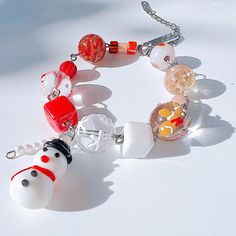 a bracelet made out of glass beads with charms on the clasp and an animal charm attached to it