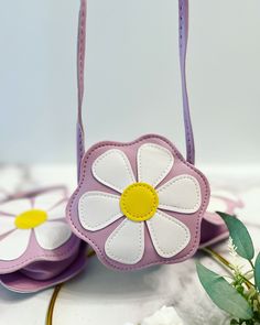 a flower purse sitting on top of a table