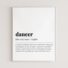 a poster with the words dancer written in black on it's white frame, against a plain wall