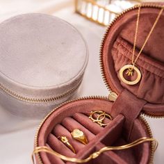 an open jewelry box with two rings inside