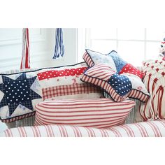 red, white and blue patriotic pillows on a bench in front of a christmas tree