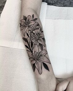 a woman's arm with flowers on it