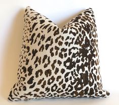 a leopard print pillow on a white wall