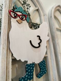 a close up of a chicken decoration on a window sill