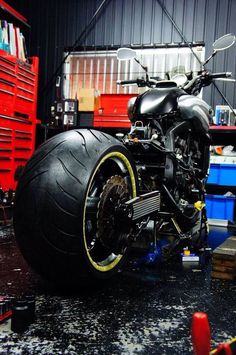 a black motorcycle parked inside of a garage