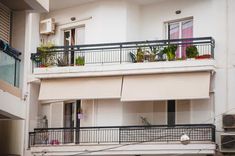 an apartment building with balconies and plants on the balcony