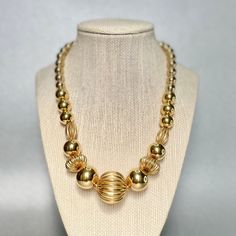 "Vintage Napier Spherical Beads Choker, Gold Tone Graduated Chunky Large Beads Necklace, Mid Century Modern Estate Jewelry, Gifts for Her. Era: Around 1955. Designer: Napier. Measurements: - Length:19\" inches. - Width: 3/8 to 1 3/4\" inches. Details: -Metal Color: Gold Tone - Embellishments: Gold Tone Plating, Chunky Spherical Beads, Graduated Necklace. - Closure: Fold over clasp. Here are more Vintage Jewelry items for your viewing pleasure: https://etsy.me/2SGhTFo Our shop team members do our Gold Metal Beaded Chain Necklace, Gold Beaded Chain Metal Necklaces, Gold Jewelry With Beaded Metal Chain, Gold Necklaces With Polished Metal Beads, Gold Jewelry With Beaded Chain, Gold Necklaces With Metal Beads, Elegant Metal Beaded Jewelry With Large Beads, Elegant Large Metal Bead Jewelry, Elegant Metal Beaded Jewelry