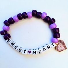 Cute Purple Kandi Bracelet That Spells Out "Sweetheart" With A Purple Glitter Heart Charm -Bracelet Is Made With Pony Beads, Elastic String, Jump Ring, And Purple Glitter Heart Charm -Bracelet Is 29 Beads Around -Made With White Letter Beads -Charm Is 0.62 X 0.60 Inches (15.9 Mm X 15.3 Mm) -Charm Is Made Out Of Resin, Glitter And Alloy Metals -Elastic String Allows More Versatile Fit To Most Sizes -Handmade By Me, Brand New, No Tags To Bundle, Please Add 2 Or More Items To Cart And Send A Bundle Offer. I No Longer Do Manual Bundles. Thanks For Understanding :) Tags: Edc, Edm, Rave, Music Festival, Kandi, Plur, Kawaii, Kandi Bracelet, Single Kandi Bracelet, Beaded Bracelet, Word Bracele Kawaii Kandi, Festival Kandi, Kawaii Bracelet, Diy Kandi Bracelets, Diy Kandi, Cute Friendship Bracelets, Kandi Ideas, Rave Music, Edm Rave