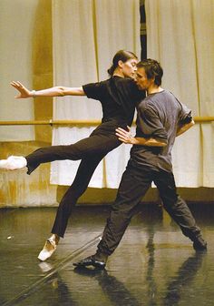 two people are dancing together on the stage