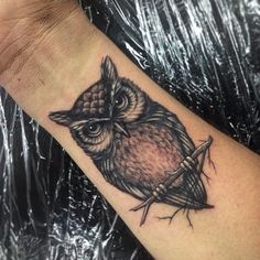 an owl tattoo on the wrist