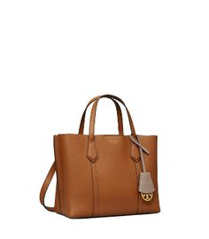 Directly from Tory Burch - Made for multi-tasking. Our Perry Small Triple-Compartment Tote Bag is made of rich Italian pebbled leather that's bonded inside - making it soft yet structured. Contrast-color details appear throughout: from the interior to the brushed gold charm. It has a center zip pocket and an optional crossbody strap. Tory Burch Official Site. Woven Sandals, Designer Tote Bags, Womens Designer Handbags, St Kitts And Nevis, Multi Tasking, Tote Bag Design, Gold Charm, Crossbody Strap, Pebbled Leather