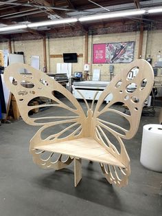 a wooden butterfly chair sitting on top of a table in a room filled with furniture