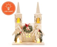 a lighted christmas church with wreath and lights