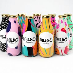 six colorful canisters are lined up against a white background with the words moloko printed on them