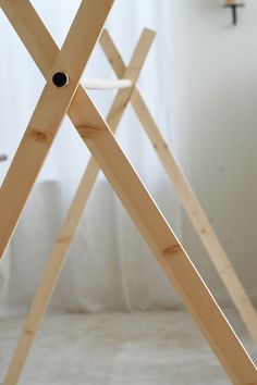 a wooden structure sitting on top of a white floor