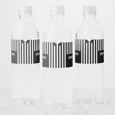 three water bottles with black and white stripes on them