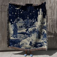 a blue and white tapestry hanging on the side of a wall