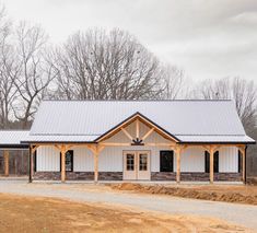 a large white building sitting on top of a dirt road