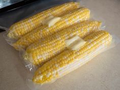 four pieces of cooked corn sitting on top of a counter