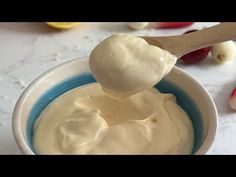 a spoon full of yogurt sitting in a bowl