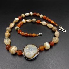 The beautiful mala necklace consist of Himalayan luk Mik or we called them magic eye bead as well in the center of the mala necklace with Banded Agate and carnelian Luk Mik means (Goat's eyes) in Tibetan Natural found from Himalaya Tibet dating more than 1000 yrs. The origin of this beads from Himalaya Tibet but also can found in India, Nepal and Pakistan too They were used as a special charm Jewelry and amulet at that time period very good condition They were used in prayers mala and used as am Single Strand Round Agate Necklace, Single Strand Agate Round Necklace, Carnelian Round Jewelry For Meditation, Round Carnelian Jewelry For Meditation, Spiritual Round Chalcedony Bead Jewelry, Spiritual Round Beads Single Strand Gemstones, Spiritual Carnelian Jewelry For Meditation, Spiritual Carnelian Necklace With Natural Stones, Round Agate Gemstones For Spiritual Use