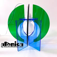 a blue and green glass object sitting on top of a white table