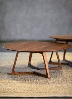 two wooden tables sitting on top of a rug