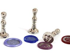 four different colored buttons and two metal candlesticks