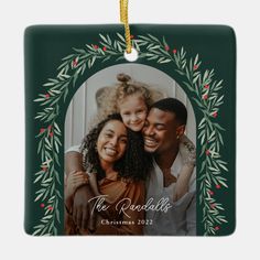 a christmas ornament with an image of two people and a child