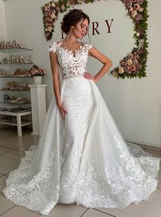 a woman in a white wedding dress posing for the camera