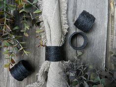 two pieces of fabric and some plants on a wooden surface