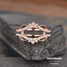 a diamond ring sitting on top of a rock