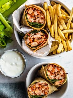 three wraps filled with meat and vegetables next to french fries