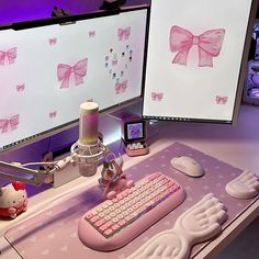 two computer screens with pink bows on them