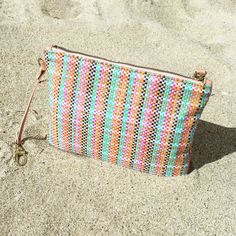 This pastel plaid pouch is an attention-grabbing accessory with a summer chic form and deceivingly spacious interior. The Sunrise Clutch effortlessly stores your phone, lipstick, wallet, and accessories. This design makes an easy piece to nest within your tote bag, or worn on its own. Size: 22cmx15.5cm 8 3/4"x 6 1/4" Summer Beach Pouch Phone Bag, Trendy Travel Phone Bag For Spring, Trendy Summer Phone Bag, Chic Multicolor Mobile Phone Bag, Casual Travel Pouch For Spring, Rectangular Travel Pouch For Summer, Leather Handle Pouch Clutch For Travel, Trendy Beach Crossbody Clutch, Chic Summer Crossbody Phone Bag