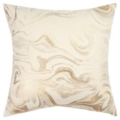 a white and gold pillow with swirls on the front, sitting against a white background