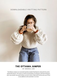 a woman holding a cup in her hands while standing next to a wall with the caption, the ottawa jumper