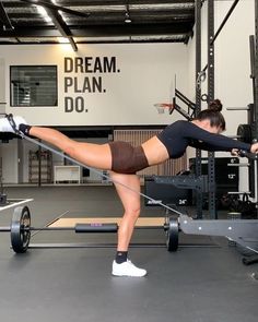 a woman doing push ups on a pull - up bar in a gym with the words dream plan do above her