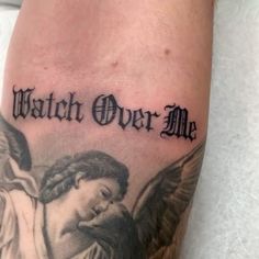 a tattoo with the words watch over me and an angel holding a baby in his arms