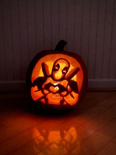 a carved pumpkin sitting on top of a wooden floor