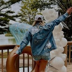 a woman standing next to a giant balloon sculpture