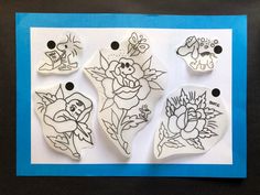 four rubber stamps with designs on them sitting on a blue and white paper sheet in front of a black background