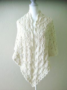 This beautiful, lacy, one-of-a-kind shawl will make a welcome gift. The lacy, openwork pattern provides warmth and elegance. Traditional triangle shape is fashionable. This shawl measures approximately 70" wide an 30" deep,  providing great coverage and flexibility. It is lightweight very soft, and has great drape. Made from  Lightweight microfiber acrylic easy-care yarn. The shawl is ready to ship. PLEASE NOTE: Items that qualify for free shipping will be shipped via USPS First Class Mail/USPS Ground Advantage. Bohemian Cream Crochet Lace Shawl, Bohemian Lace Shawl In Cream, Bohemian Lace Shawl In Cream Color, Bohemian Cream Lace Shawl, Cream Crochet Lace Shawl, Winter Shawl Crochet, Shawl Crochet, Winter Shawl, Welcome Gifts